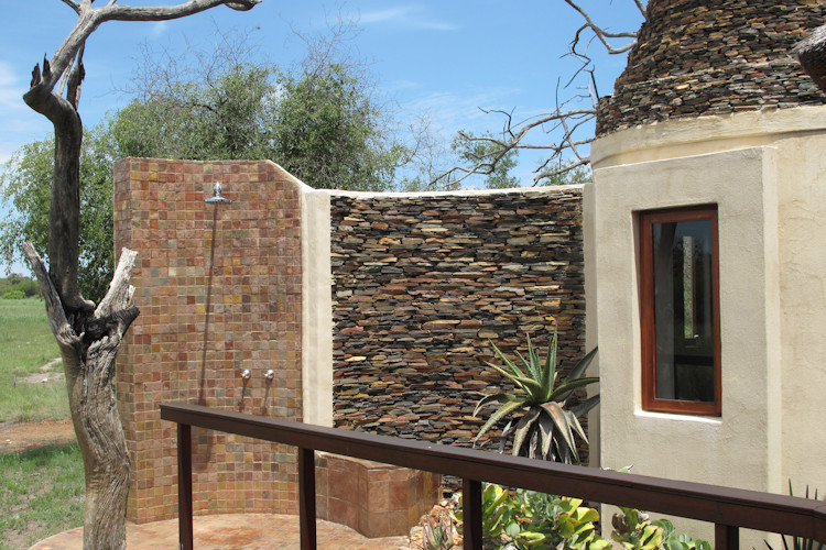 Jamala Madikwe Lodge villa lounge fireplace 180 degree bush views mosquito net elephant herd outdoor shower