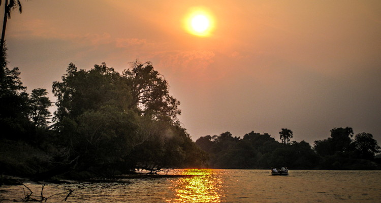 Tongabezi Lodge Victoria Falls sampan floating deck silver service dinner for two Zambezi River anchored