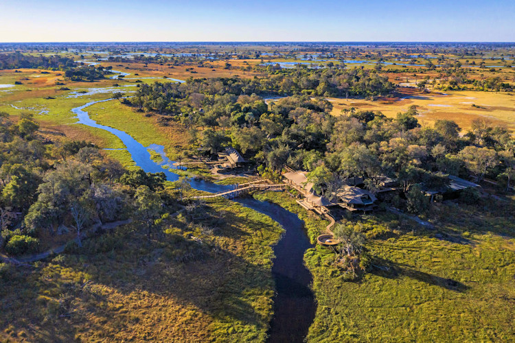 10-best-lodges-in-okavango-delta-2.jpg A scenic view of Xigera Safari Lodge, highlighting its elevated canvas tents and the surrounding natural beauty of the Okavango Delta