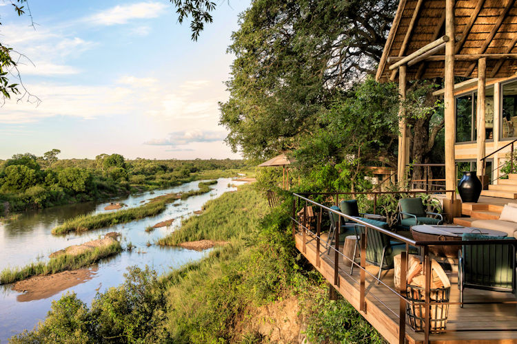 10-best-lodges-in-the-sabi-sand-game-reserve-2.jpg The image depicts the luxurious Singita Ebony Lodge, nestled in the Sabi Sand Game Reserve, with stunning views of the Sand River. The lodge features stylish suites, private plunge pools, and an ideal setting for an authentic safari experience amidst abundant wildlife, offering guests complete privacy and world-class hospitality.