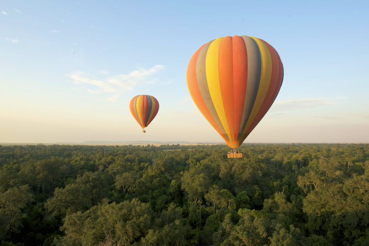 Hot air balloon Maasai Mara Kenya Great Migration rolling hills sunrise wildlife lions elephants