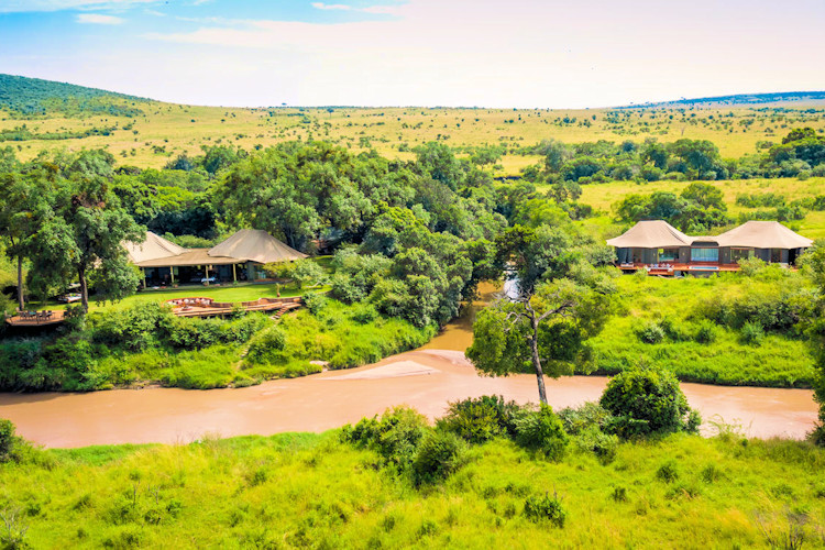 best-maasai-mara-lodges-and-safari-camps-3.jpg Elegant view of Sala's Camp by the river, showcasing its luxurious tents in a tranquil setting.