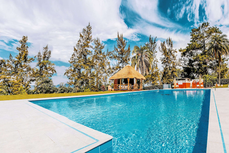 Hotel des Mille Collines Kigali Rwanda cultural haven 1994 history local artistry pool fitness spa