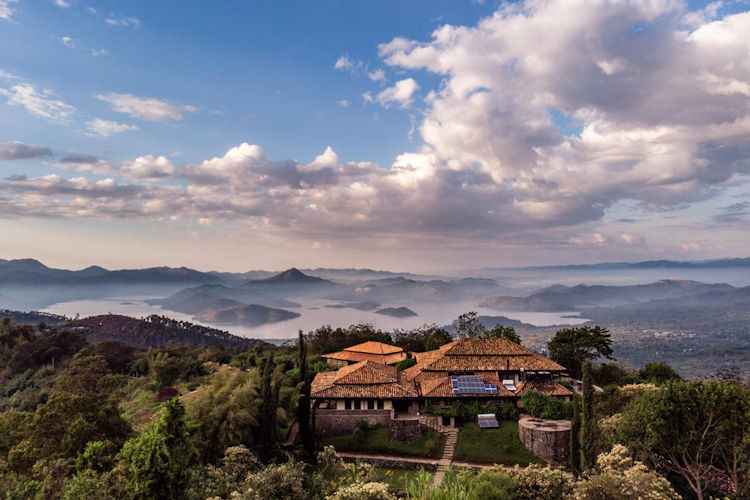 Couple Rwanda honeymoon safari Virunga Mountains mist rolling hills Volcanoes National Park romance