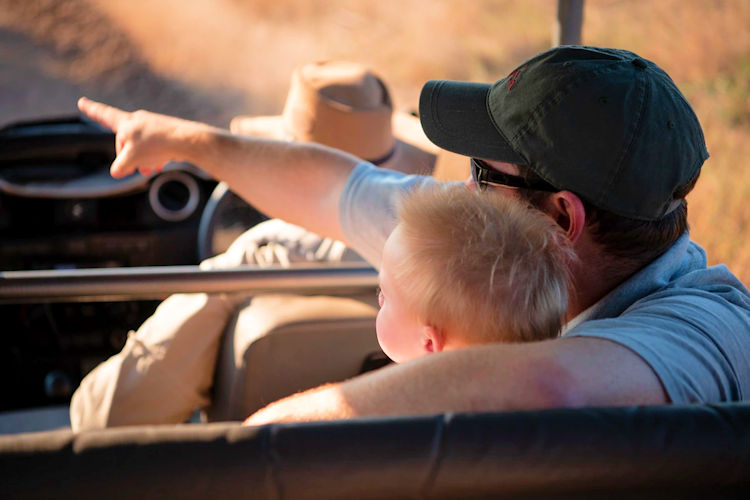 A family enjoying a tanzania family safari amidst the wild african savanna.