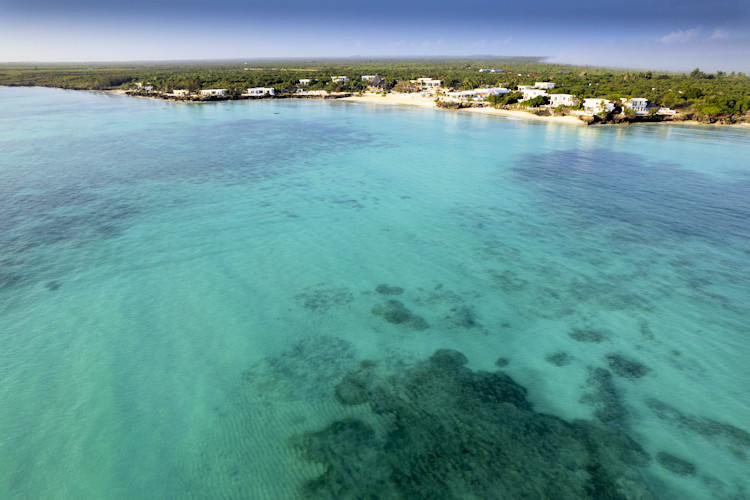 Nungwi Beach Zanzibar northern tip crystal-clear waters coral reefs beach parties sunset cocktails