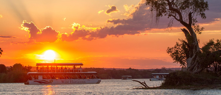 Zambezi sundowner cruise gin tonic Zambezi lager upper Zambezi hippo elephant riverbank sunset