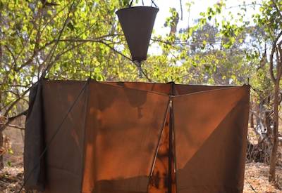 Outdoor bush shower semi-participation camping Botswana Lion Safari Moremi Chobe
