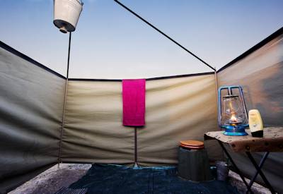 En-suite tented bathroom bucket shower Delta Miracle Safari Moremi Okavango Botswana