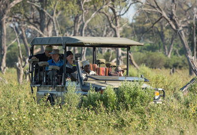 Game drive vehicle guests guide Xaxaba Moremi Game Reserve Delta River Safari Botswana