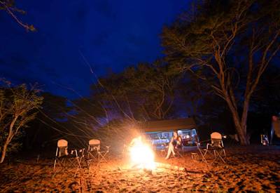 Campfire night under stars Savuti Discover Botswana luxury mobile tented safari