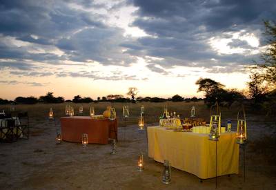 Dining under African stars open fire 3-course dinner Discover Botswana Camping Safari