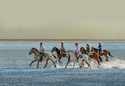 Water crossing on horseback Makgadikgadi Pans Kalahari Desert Botswana family safari