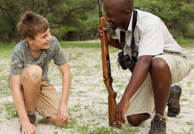 Children learning about wildlife tracks animal behaviour Okavango Delta Botswana family