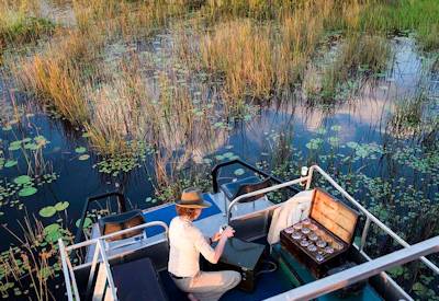 Mokoro boating papyrus channels private island overnight Okavango Delta Botswana