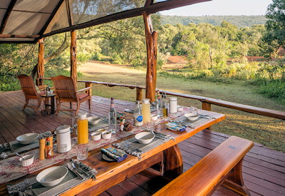 Outdoor dining with views of Masai Mara