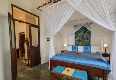 Ibo Island Lodge king four-poster handcrafted bed Indian silk cotton linen Quirimbas