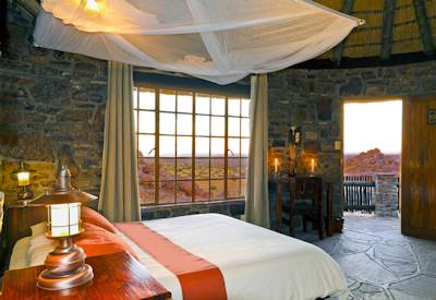 Thatched and stone bedrooms with air conditioning