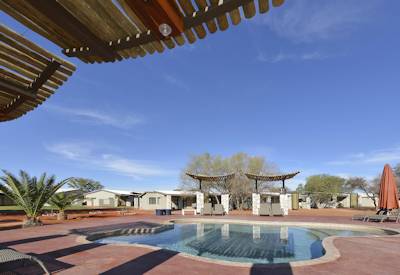 Pool under the Kalahari sun with sun loungers and pool umbrellas