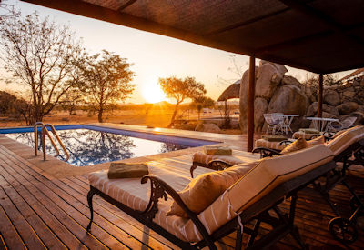 Swimming pool with wooden deck and sun loungers