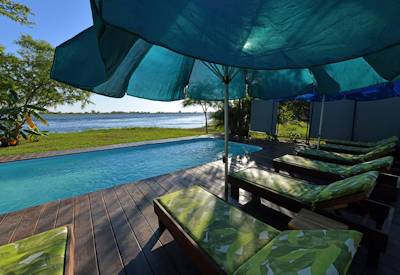 Mubala swimming pool with sun loungers and pool umbrellas