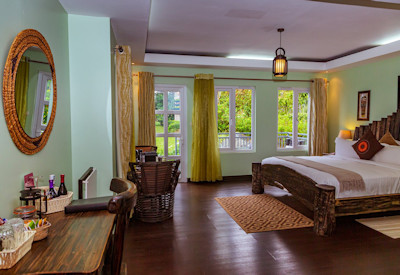 Amakoro Songa Lodge beautifully appointed bedroom fireplace farm-to-table Rwanda