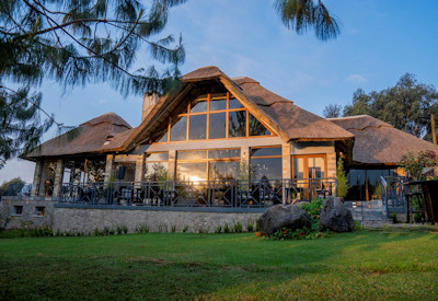 Amakoro Songa Lodge thatched central guest area fireplace indoor lounge Rwanda