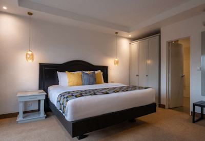 Hôtel des Mille Collines large classic bedroom Pan-African décor satellite TV Kigali Rwanda