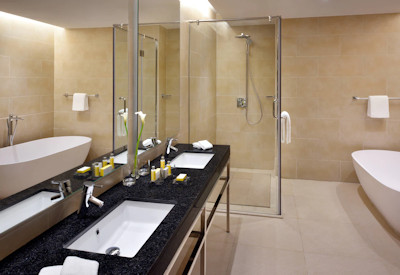 Kigali Marriott Hotel large en-suite bathroom marble rainfall shower Kigali Rwanda