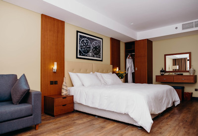 Mantis Kivu Marina Bay Hotel large luxurious room brown golden tones Lake Kivu Rwanda