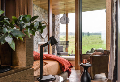 Singita Kataza House en-suite bedroom local artworks glass windows landscape views Rwanda