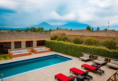 Tiloreza Volcanoes Ecolodge exterior stone and thatch architecture lush gardens northern Rwanda gorilla trekking base