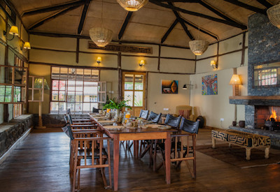 Virunga Lodge indoor dining large fireplace 3-course dinner Musanze Rwanda