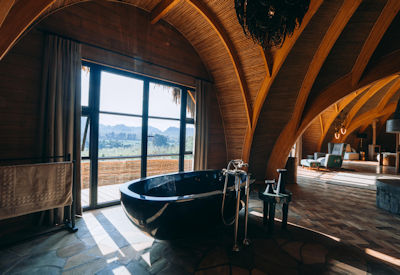 Wilderness Bisate Reserve en-suite bathroom outdoor shower deep soaking tub Rwanda