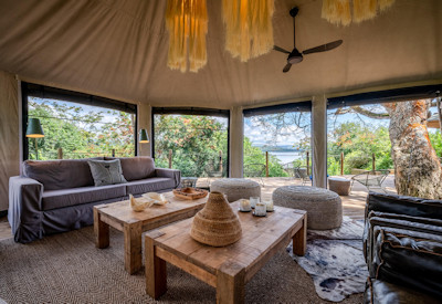 Wilderness Magashi lounge expansive wooden deck Lake Rwanyakazinga hills views Rwanda