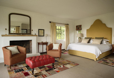Wilderness Sabyinyo Silverback Lodge beautifully appointed room sitting area sheltered veranda Rwanda