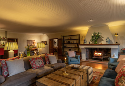 Wilderness Sabyinyo Silverback Lodge main lounge large fireplace volcano views Rwanda