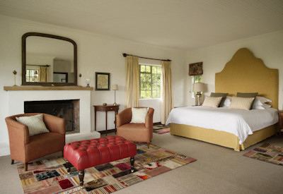 Wilderness Sabyinyo Silverback Lodge large luxurious four-poster suite fireplace Rwanda