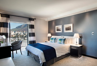 Kingsized bed with views of Table Mountain