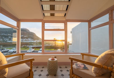 Tintswalo Summer House luxury suite sea view king bed colour-themed interior Glencairn Cape Town