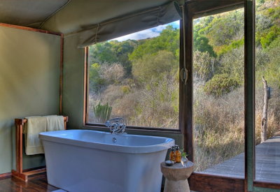 Freestanding bathtub with indoor and outdoor showers at Amakhala Hillsnek Lodge Eastern Cape