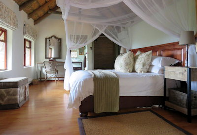 Stone and thatch sleeping lodge exterior at Amakhala Woodbury Lodge Amakhala Game Reserve