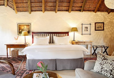 Antique-furnished luxury suite with African art at The Elephant House Addo Eastern Cape