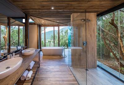 Freestanding bath and glass indoor outdoor showers at Kariega Settlers Drift Eastern Cape