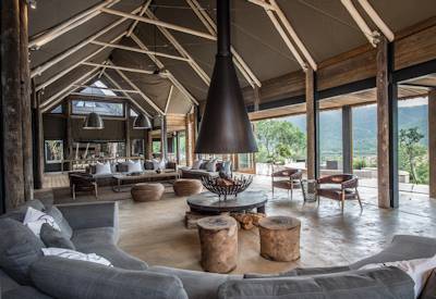 Main lounge with open fireplace and wine cellar at Kariega Settlers Drift Kariega Game Reserve
