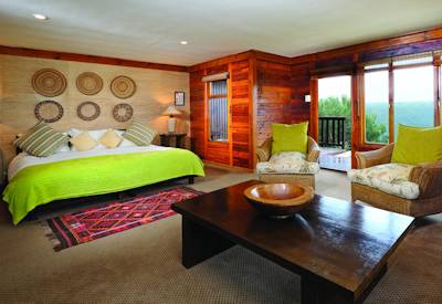 Luxury log chalet bedroom with panoramic Kariega Game Reserve views at Kariega Ukhozi Lodge