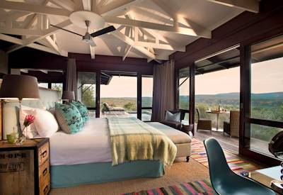 Luxury en-suite safari suite with African bush-inspired decor at Kwandwe Ecca Lodge Eastern Cape