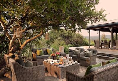 Wooden deck outdoor lounge with shale cliff valley views at Kwandwe Ecca Lodge Kwandwe Reserve