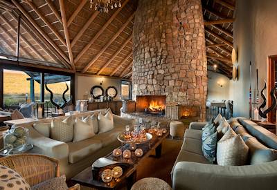 Soaring ceilings stone chimney lounge at Kwandwe Great Fish River Lodge Kwandwe Game Reserve