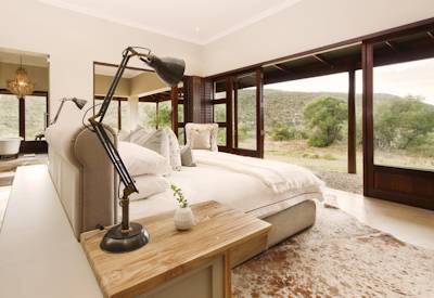 Eclectic frontier farmhouse interior with vibrant decor at Kwandwe Melton Manor Kwandwe Reserve